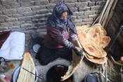 KABUL, June 4, 2023 (UNI/Xinhua) -- A woman bakes naan, Afghan traditional flatbread, in Kabul, Afghanistan, June 4, 2023. UNI PHOTO-11F