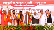PORBANDAR, APR 27 (UNI):- Union Minister for Home Affairs and Cooperation Amit Shah and Minister for Health and Family Welfare and Chemicals and Fertilizers Mansukh Mandaviya being garlanding by the party workers at an election rally for Lok Sabha Election - 2024, in Porbandar, Gujarat on Saturday. UNI PHOTO-64U
