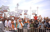 PORBANDAR, APR 27 (UNI):- BJP supporters at an election rally addressed by Union Home Minister Amit Shah for Lok Sabha Election - 2024, in Porbandar, Gujarat on Saturday. UNI PHOTO-65U